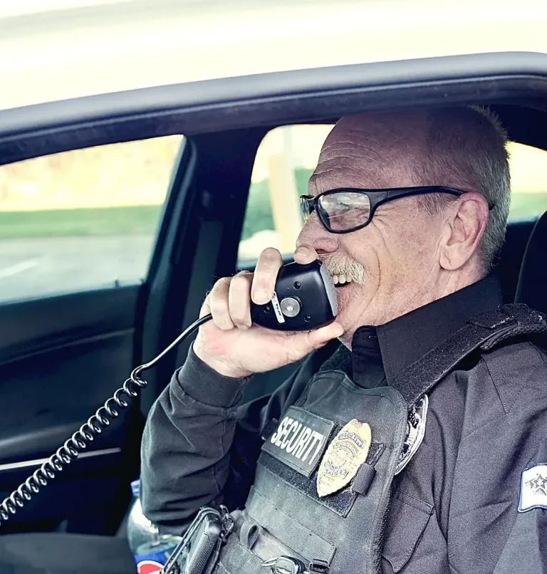 Safeguard On Demand officer on the radio from a patrol vehicle