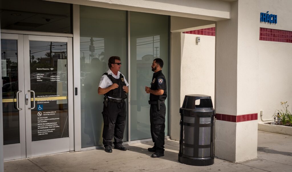 Two Safeguard On Demand armed security guards posted at a Bank of America branch entrance in Southern California