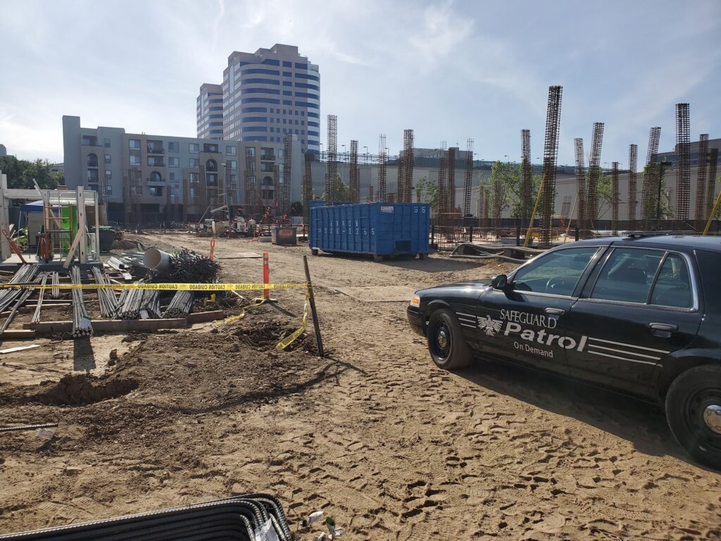 Safeguard On Demand patrol car parked on an active construction site with rebar and materials in California