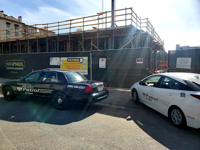 Safeguard On Demand marked patrol vehicles posted at the gate of a construction site