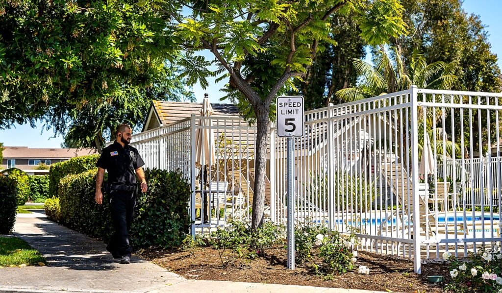 Safeguard On Demand HOA security officer on foot patrol beside a community pool in California