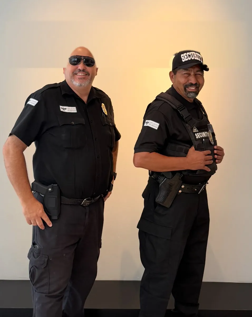 Two armed Safeguard officers on post at a Coachella Valley event